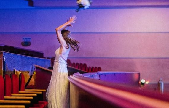 Bride throwing bouquet off balcony